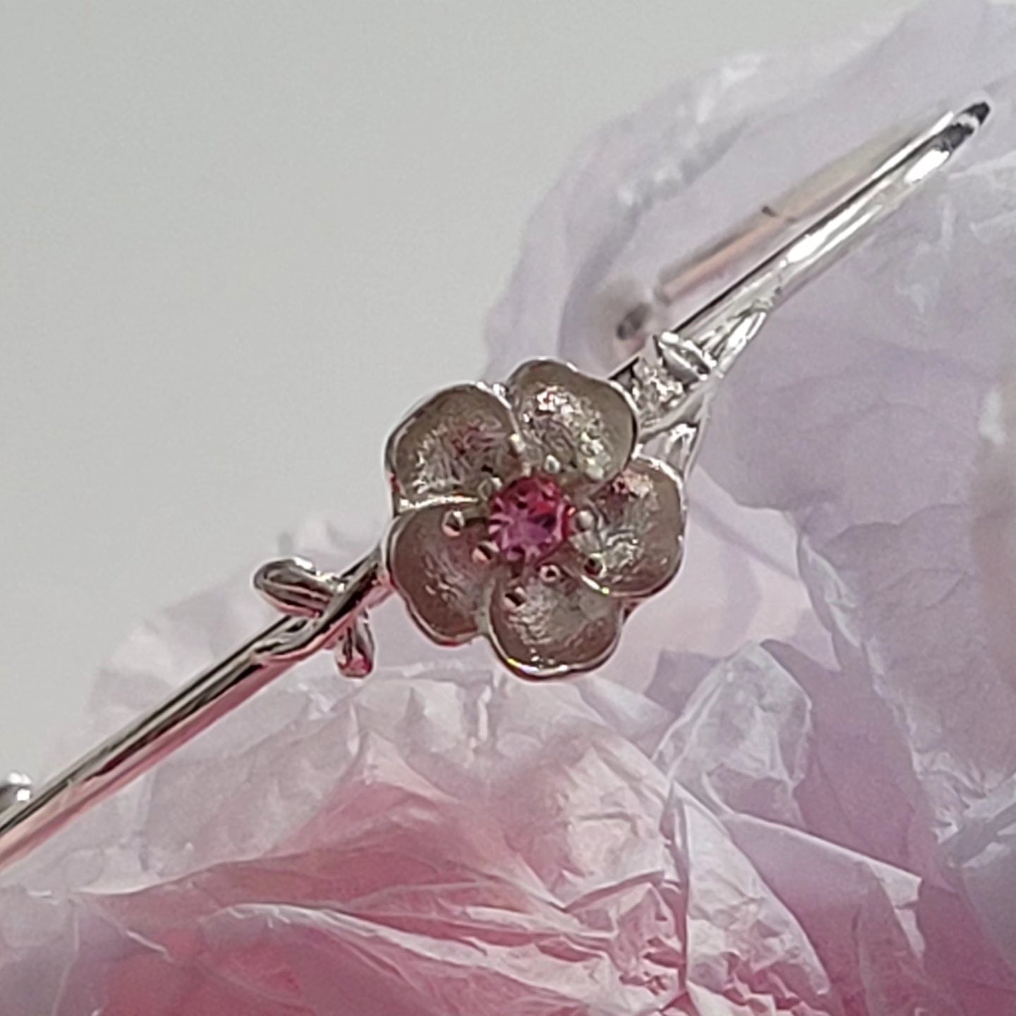 Rhodium plated pink rose charm open bangle