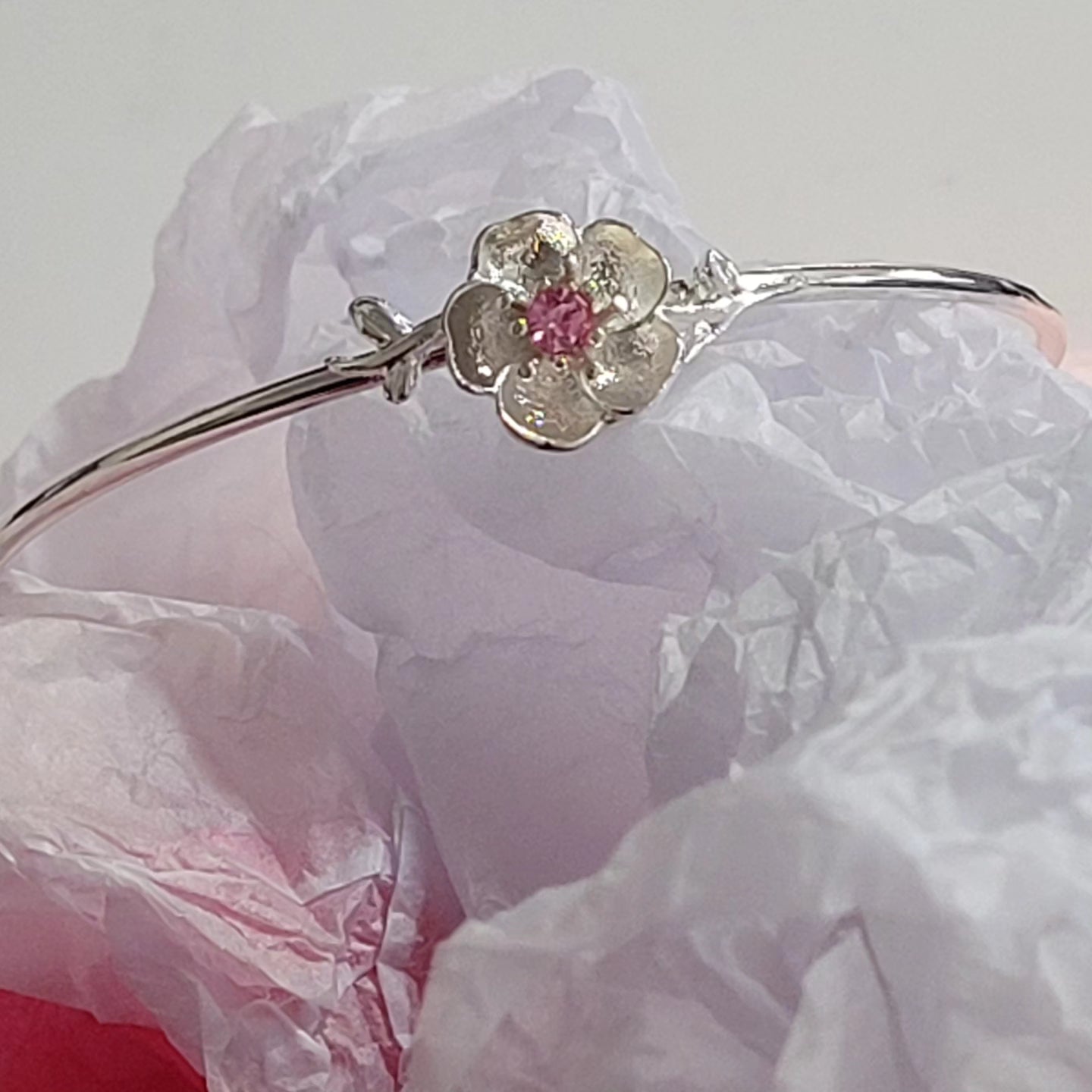 Rhodium plated pink rose charm open bangle