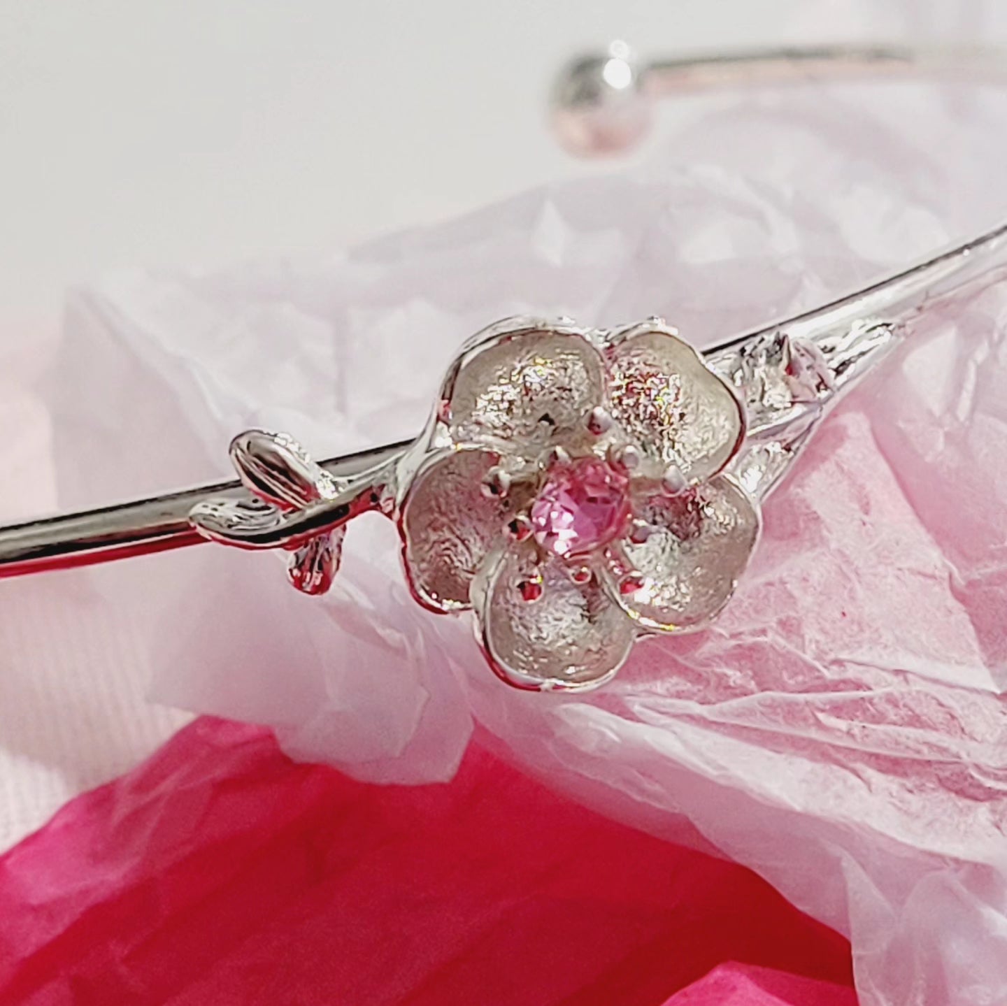 Rhodium plated pink rose charm open bangle